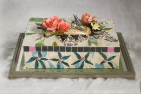 glass, ceramic and tile with etched Scrimshaw, Wadde figurines, Capodimonte Roses, vintage Staffrodshire flowers on a marble slab. 13 x 9 1/2 inches