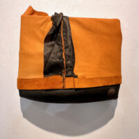 2024. suede jacket inner tube on wood 11 x 13 1/2 x 3 inches